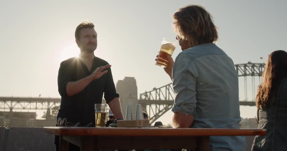 Two men have some drinks outside