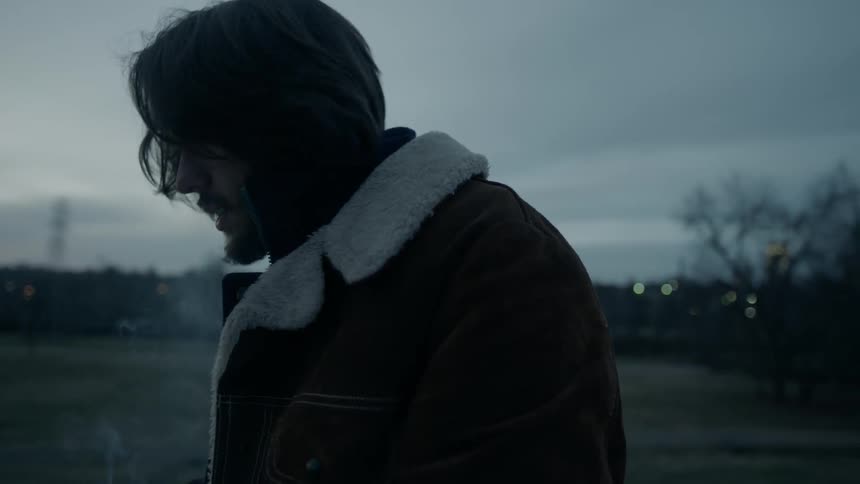 A man smokes outside in the cold