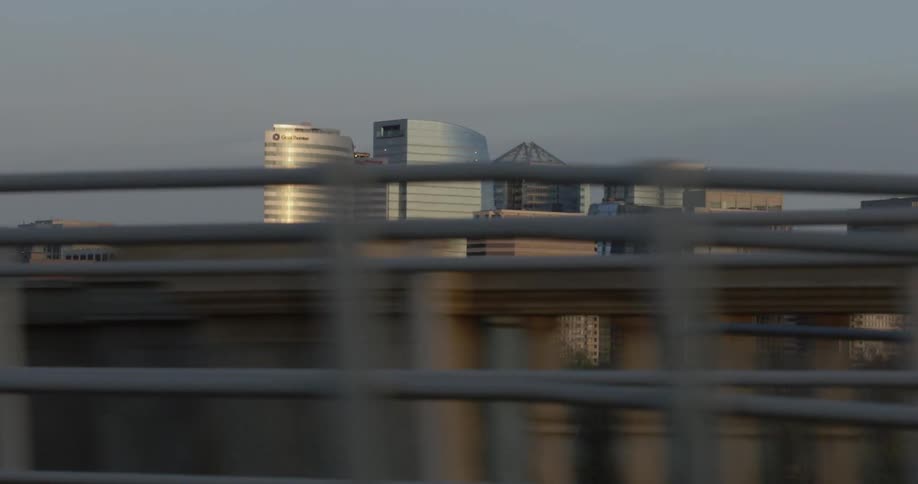 City buildings and harbor seen from a bridge