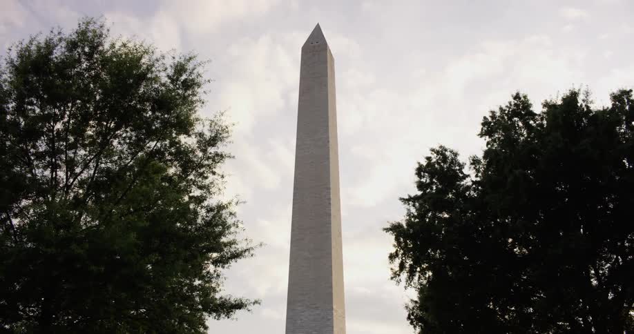 Tall cement structure stands tall between two trees