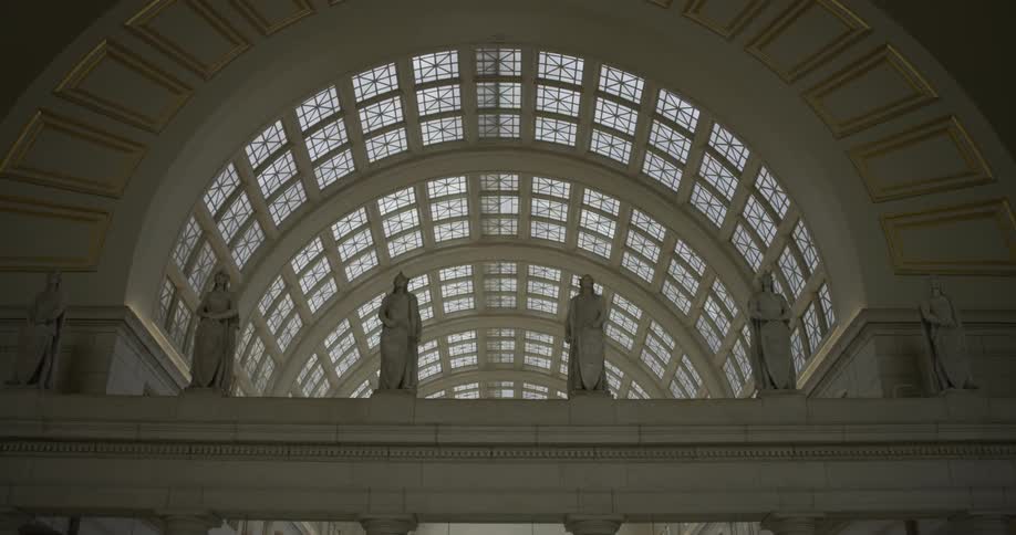 Statues hang above the walkway
