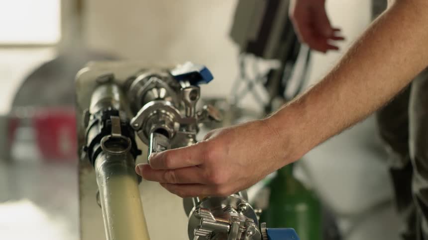 Steam pours into the are in a brewery