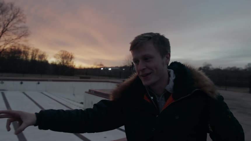 A man talks by the empty pool at dawn