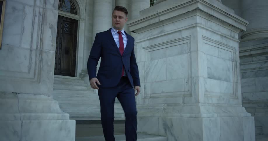 A man walks down the stone steps