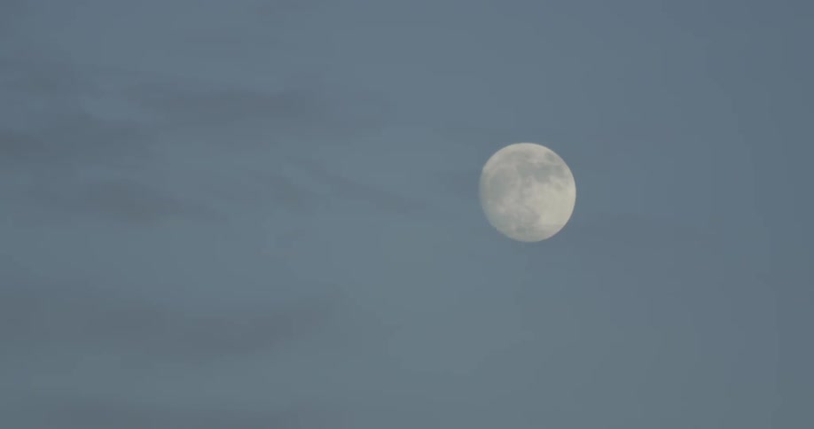 The moon is high in the clear sky