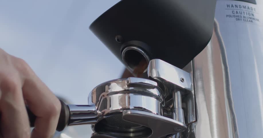 Coffee beans are ground up by a machine