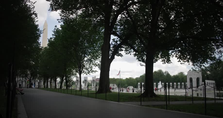 Trees line the walkway by monuments