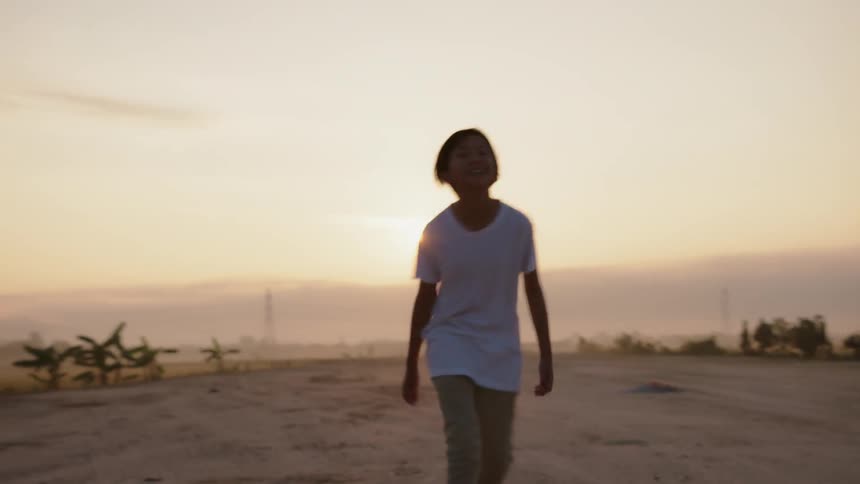 A young boy walks outside