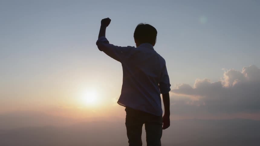 A young boy holds his arm up