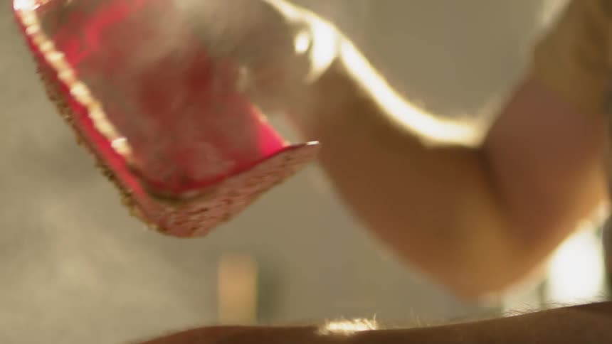 A person digs into a steaming container