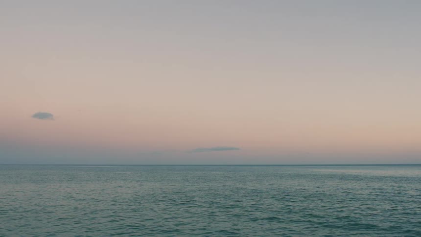 Water flows on an ocean at dawn