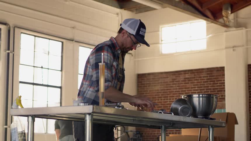 A man is working on a table in the warehouse