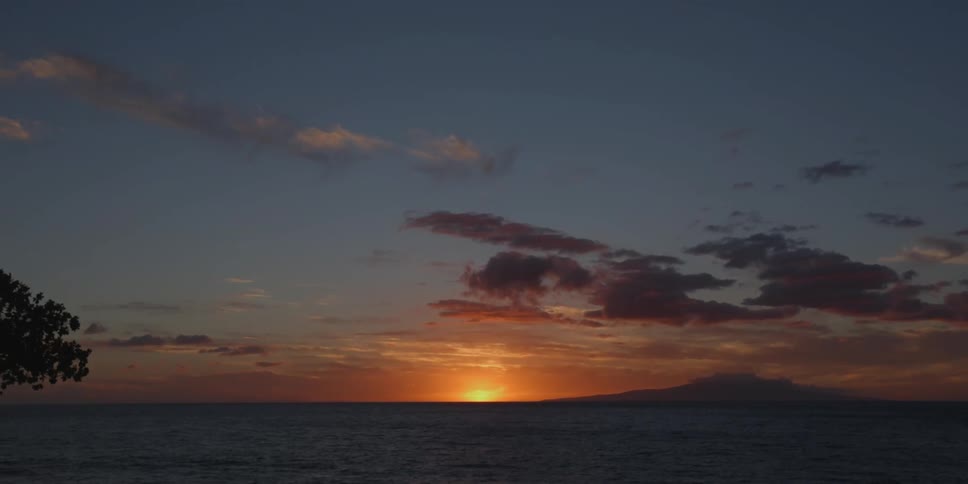 The sun setting behind the ocean