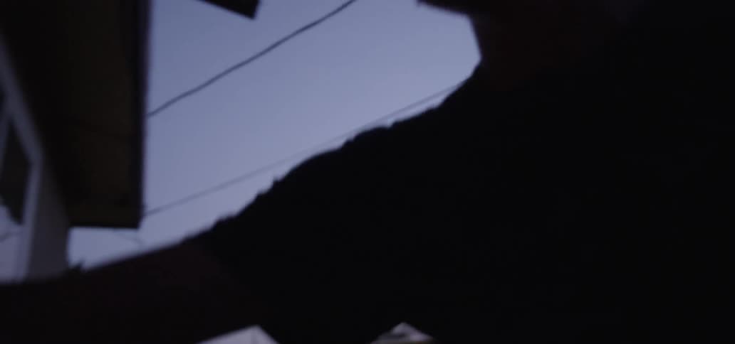 A man walks into a house at dawn