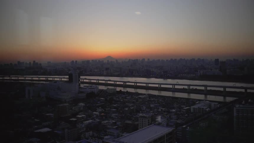 The sun sets with Mount Fuji in the background