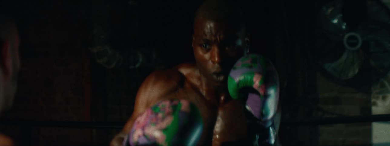 Two young men practice boxing jabs