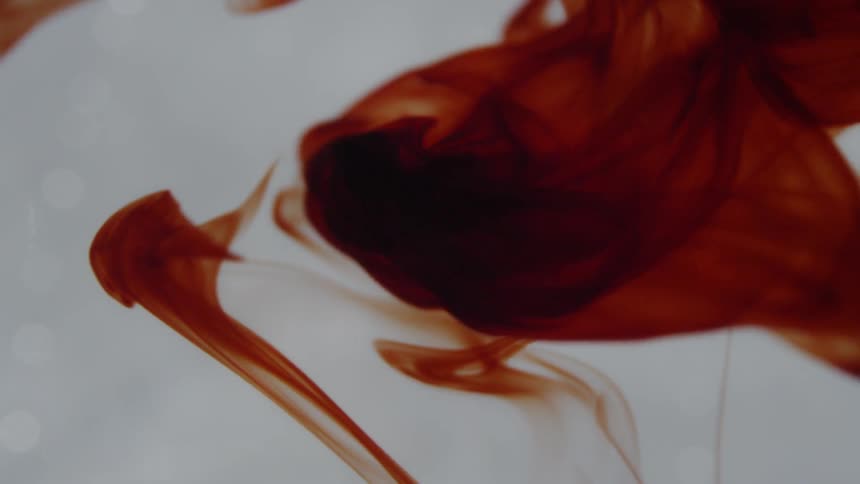 Red liquid pours into clear liquid