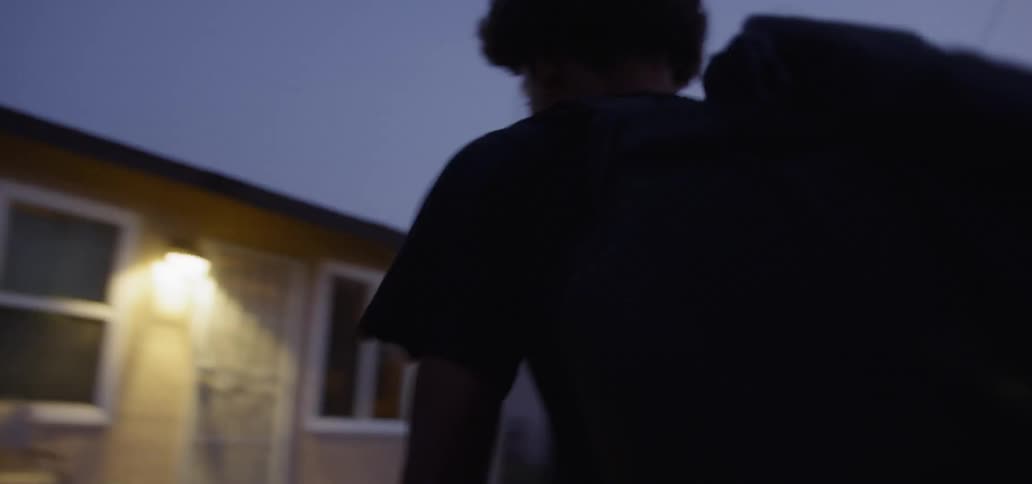 A teenage boy rides his bike home
