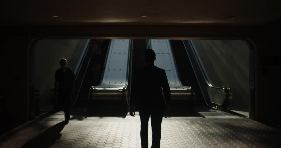 People walk on the escalator