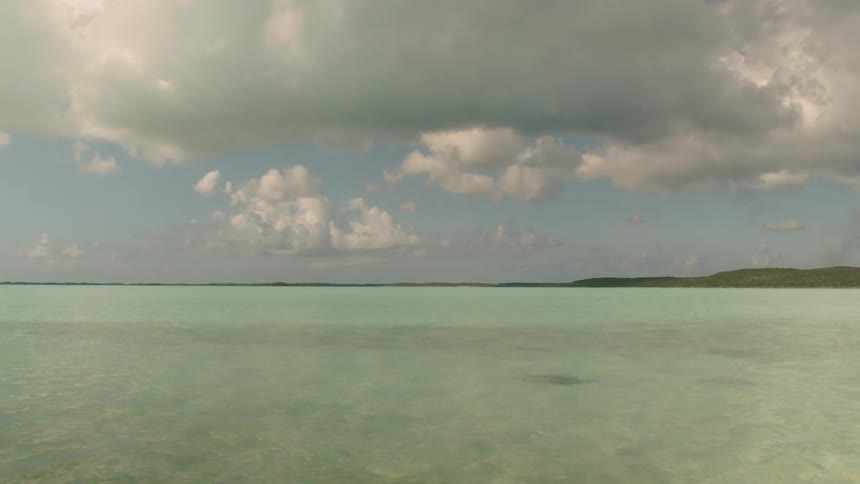 Water flows gently under a cloudy sky