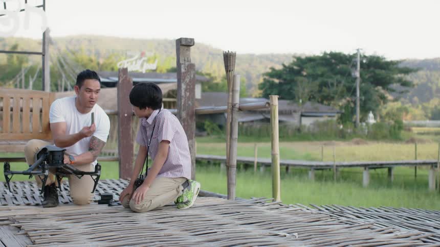 Two men work on a drone