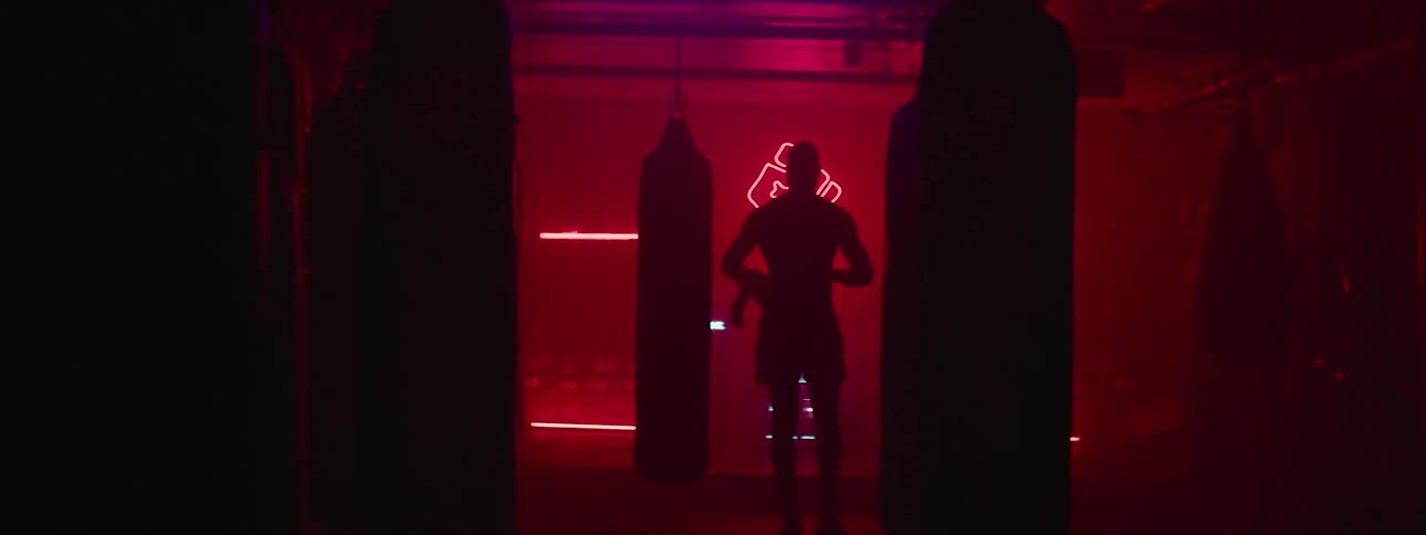 A man walks through a boxing gym