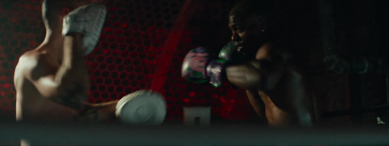 Two men practice boxing in a boxing ring