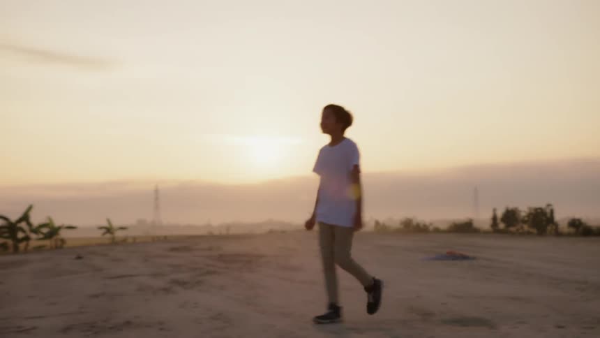 Woman swings her arms as she walks in a field