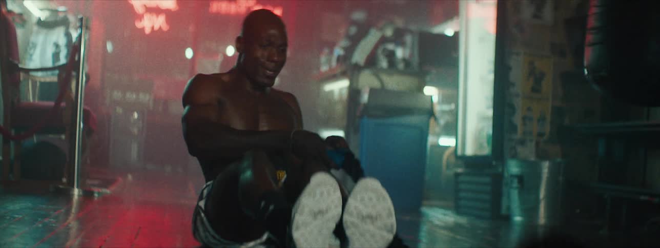 Man works out by swinging two heavy ropes