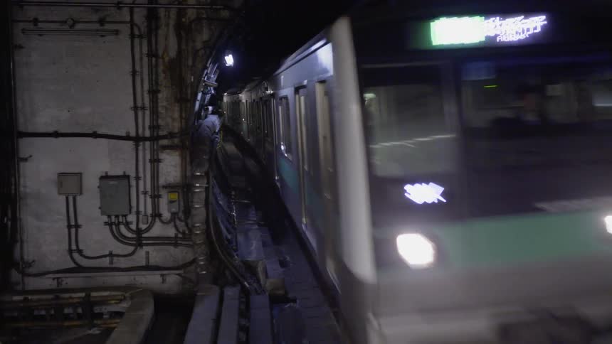 The subway train races down the tracks