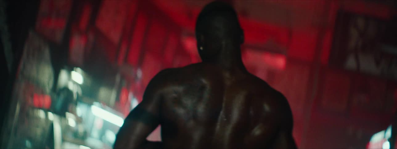 A man is working out in a gym sweating