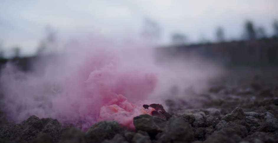 Pink smoke pours from the ground