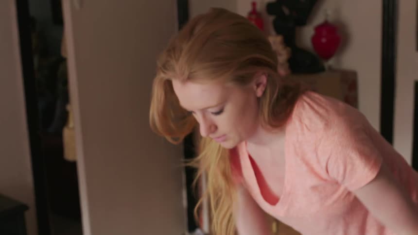 A woman picks up dirty laundry