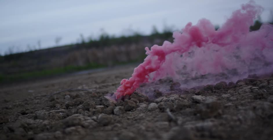 Pink smoke pours from the ground