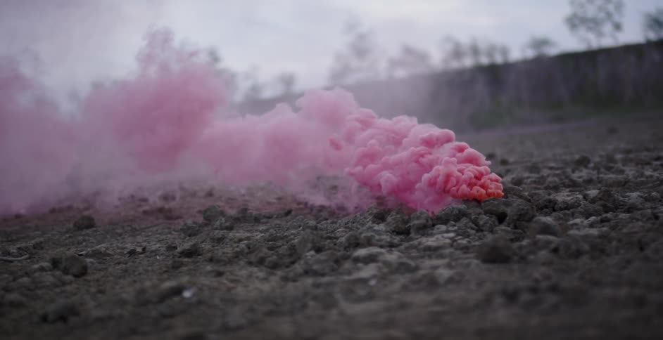 Pink smoke pours from the ground