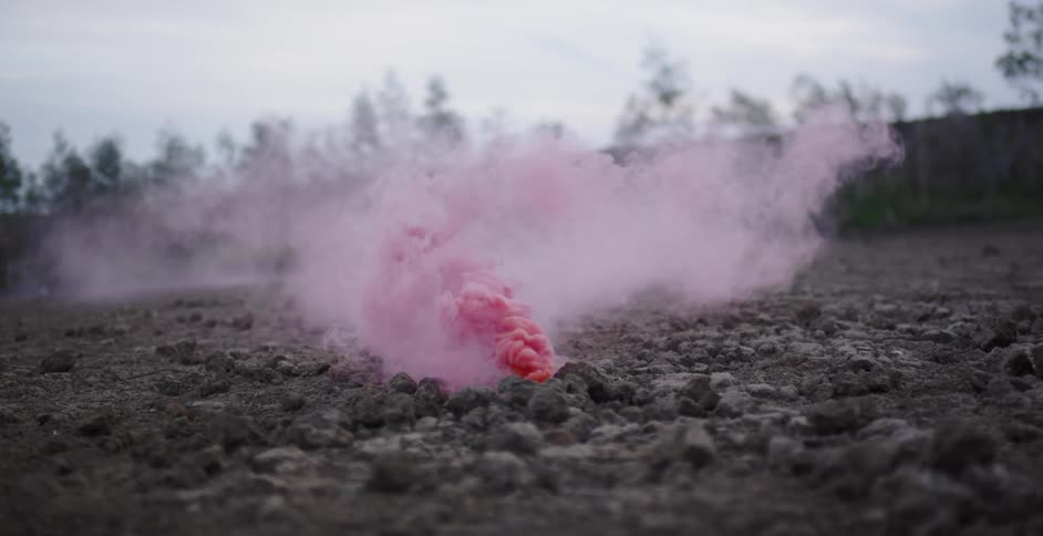 Pink smoke pours from the ground