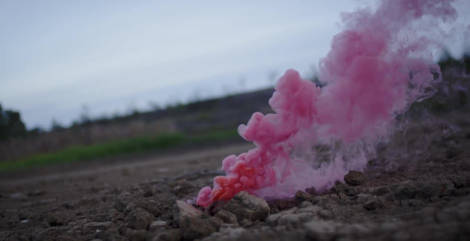 Pink smoke pours from the ground