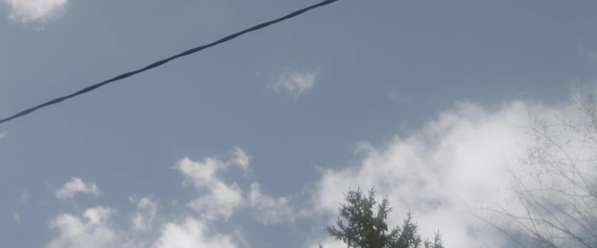 Power lines with clouds overhead
