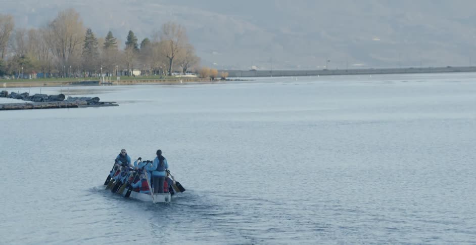 People row a small boat together