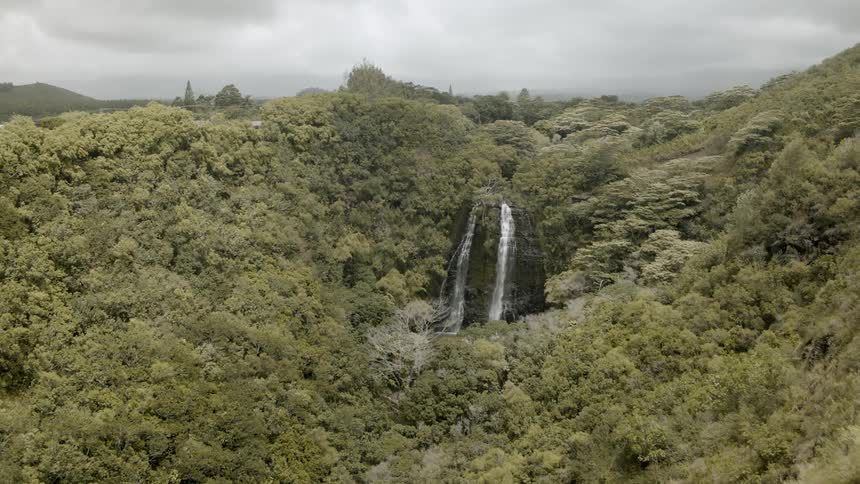 Water falls off the cliff into the ravine