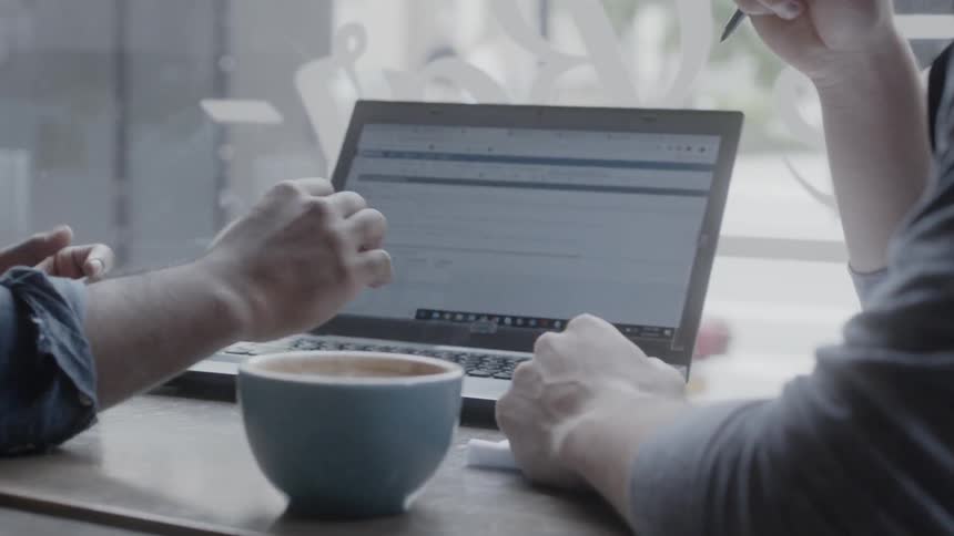 Two men work in a coffee shop