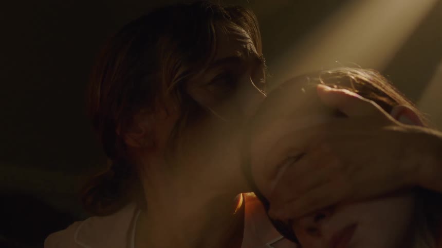 A woman holds her children in the dark