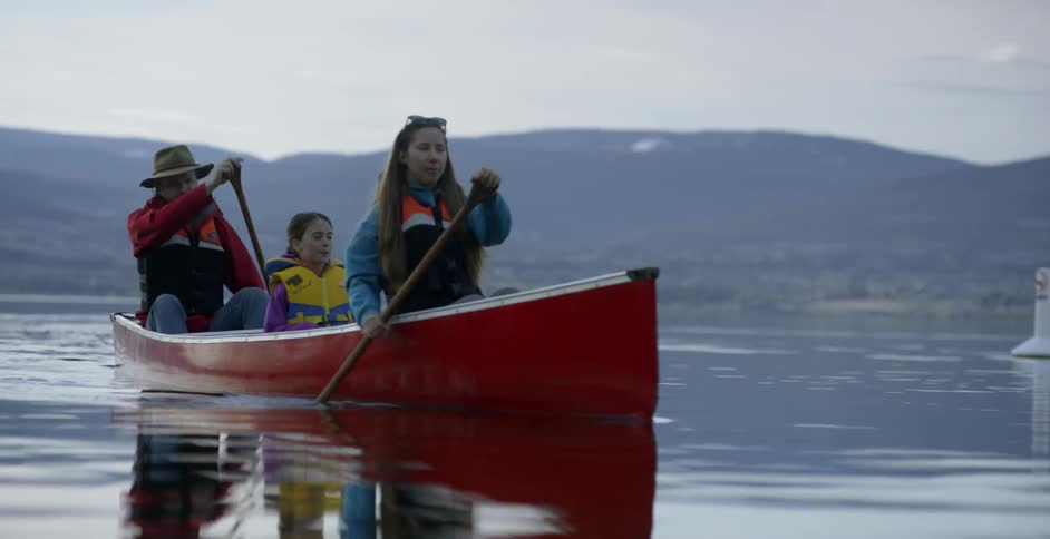 A family rows a boat together