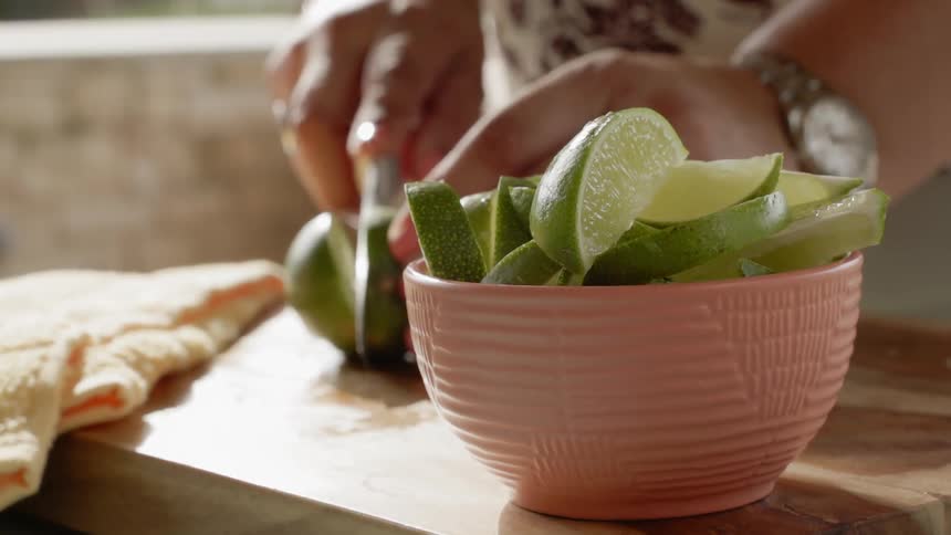 A woman slices a lime