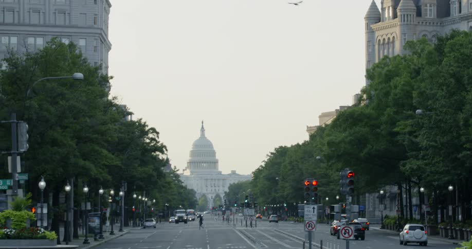 People and cars travel on the large street