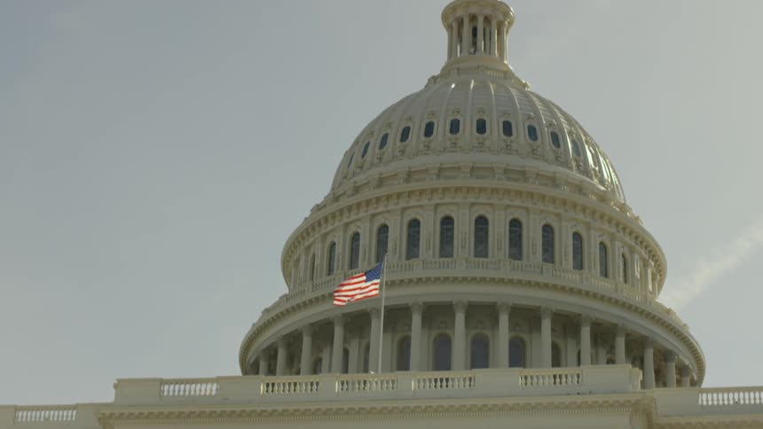 The flag flies on the side of the building