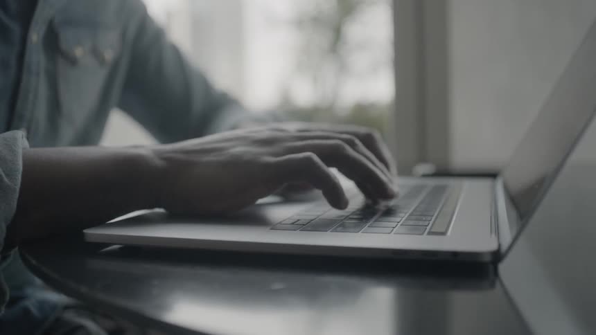 Person opens a laptop and starts typing