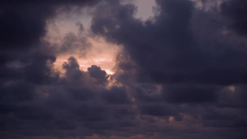 Clouds float in the sky at sunset