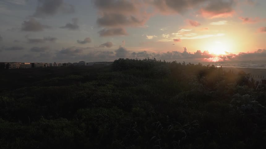 The sun sets over a beach