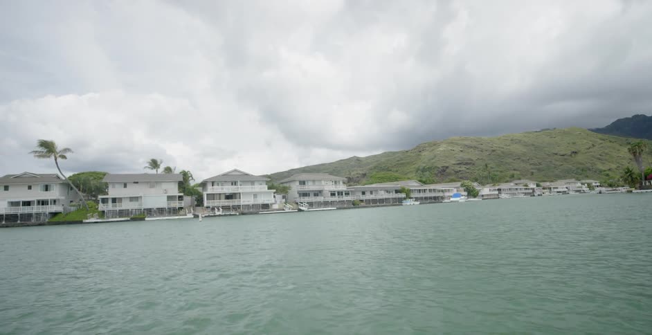 Cloudy skies over large lakeside homes